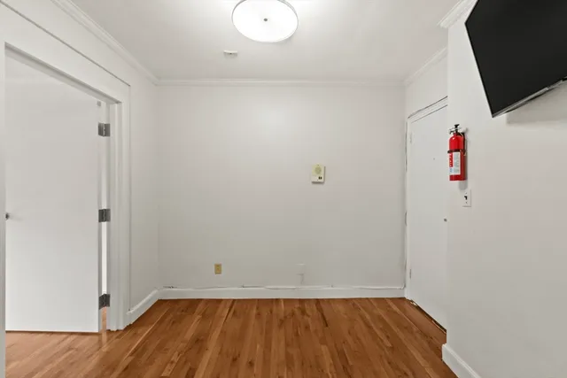 a view of room with wooden floor