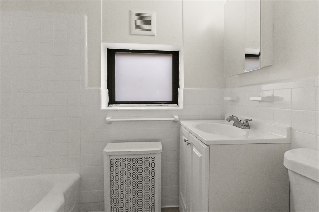 38-40 Cedar Street, Unit 141 Worcester, MA 01609 - Photo 9 of 26 a bathroom with a sink and a toilet