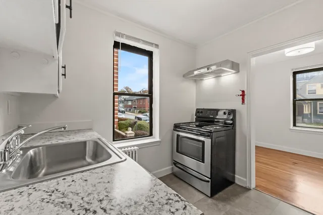 a kitchen that has a sink cabinets appliances and a window