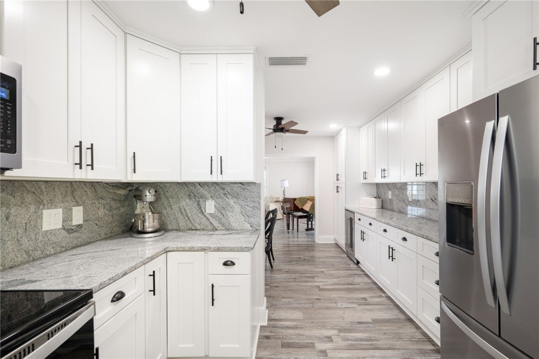 1180 Reef Road, Unit A20 Vero Beach, FL 32963 - Photo 12 of 32 a kitchen with granite countertop a sink a counter space and stainless steel appliances