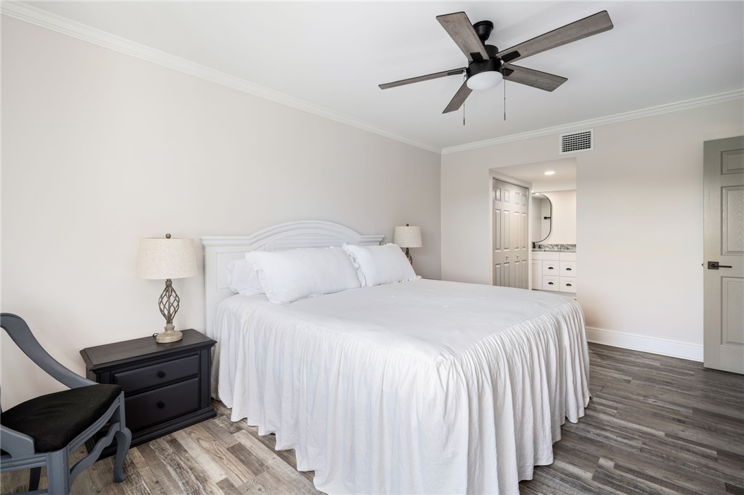 1180 Reef Road, Unit A20 Vero Beach, FL 32963 - Photo 14 of 32 a bedroom with a bed and a chandelier