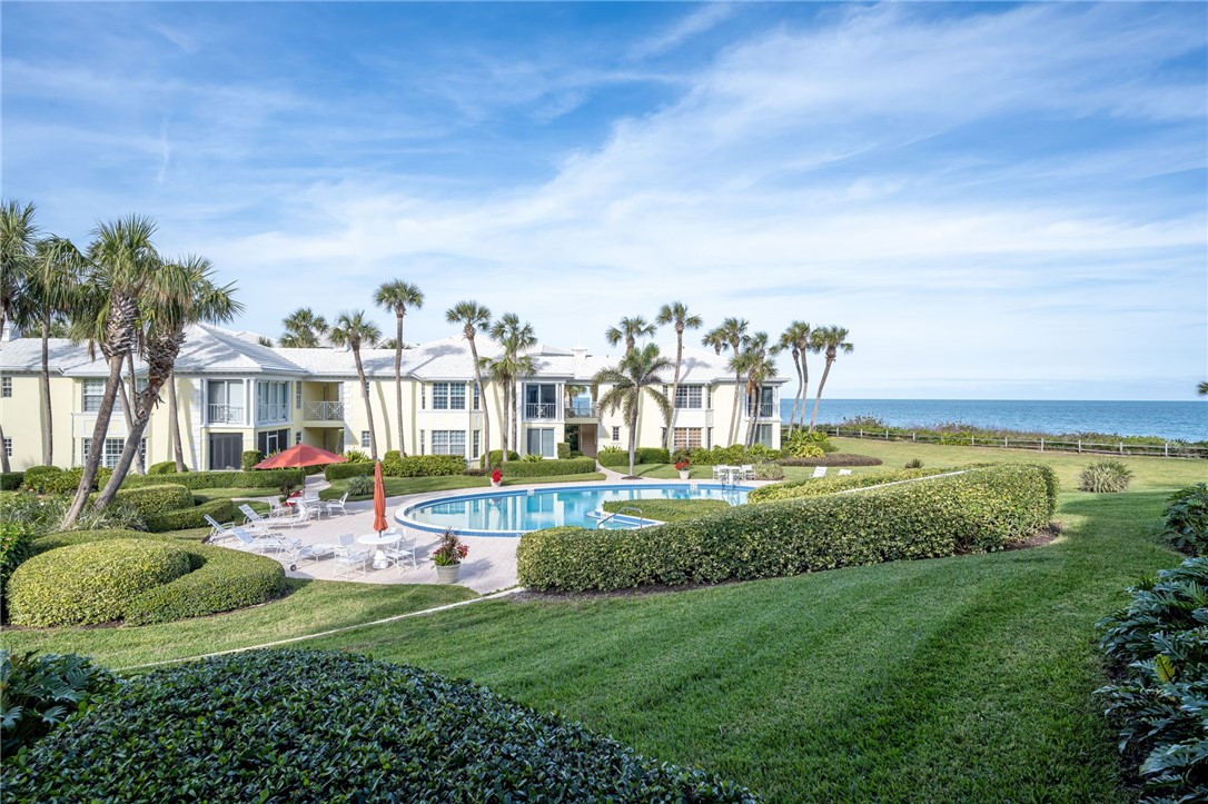 1180 Reef Road, Unit A20 Vero Beach, FL 32963 - Photo 19 of 32 a view of a house with a big yard and potted plants