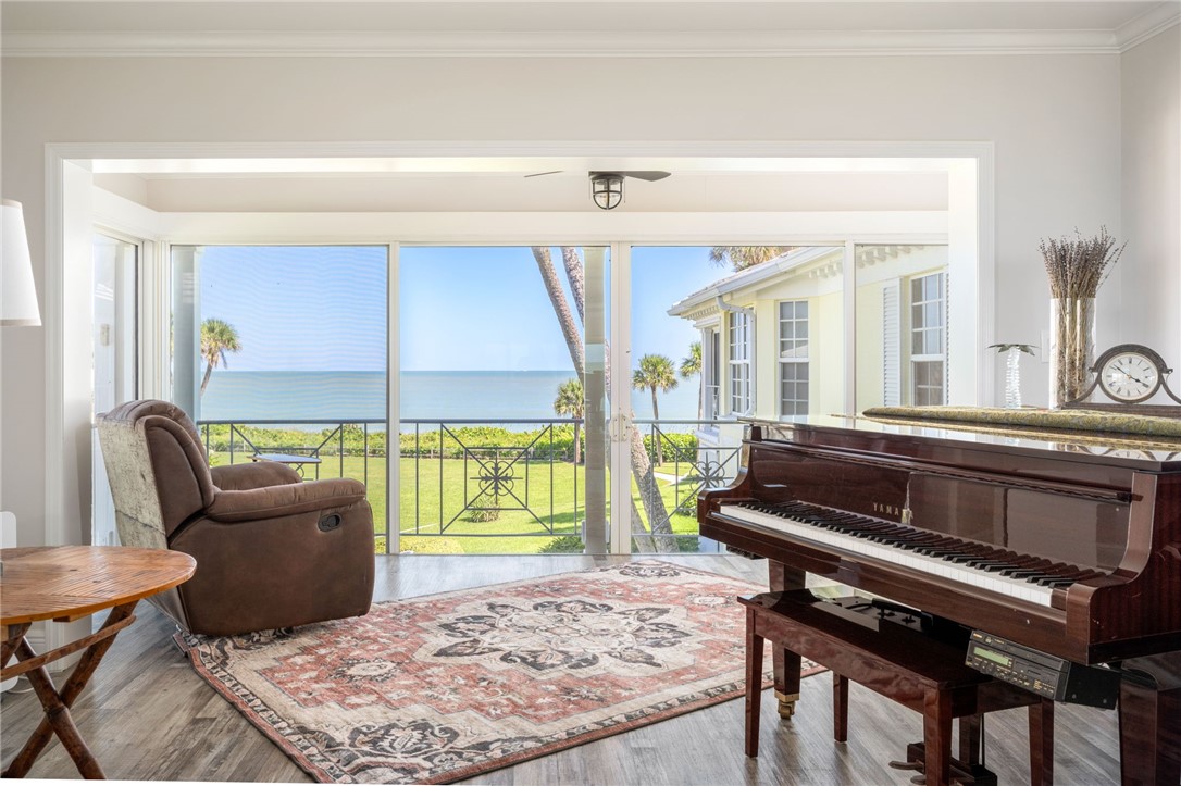1180 Reef Road, Unit A20 Vero Beach, FL 32963 - Photo 2 of 32 a living room with furniture and a floor to ceiling window