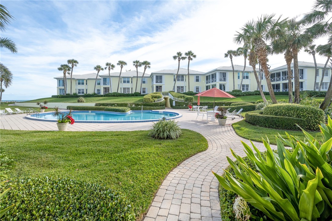 1180 Reef Road, Unit A20 Vero Beach, FL 32963 - Photo 21 of 32 a view of yard with swimming pool outdoor seating and barbeque oven
