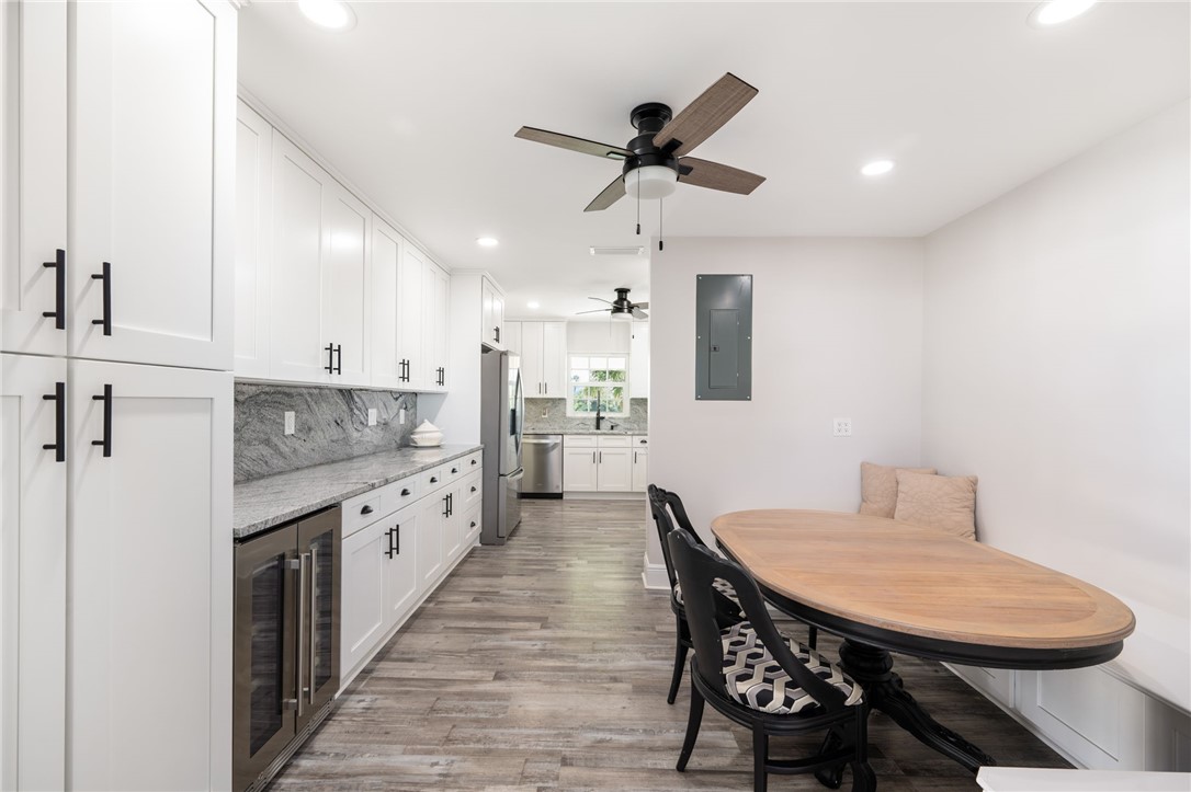 1180 Reef Road, Unit A20 Vero Beach, FL 32963 - Photo 9 of 32 a kitchen with stainless steel appliances kitchen island granite countertop a sink a stove a table and chairs