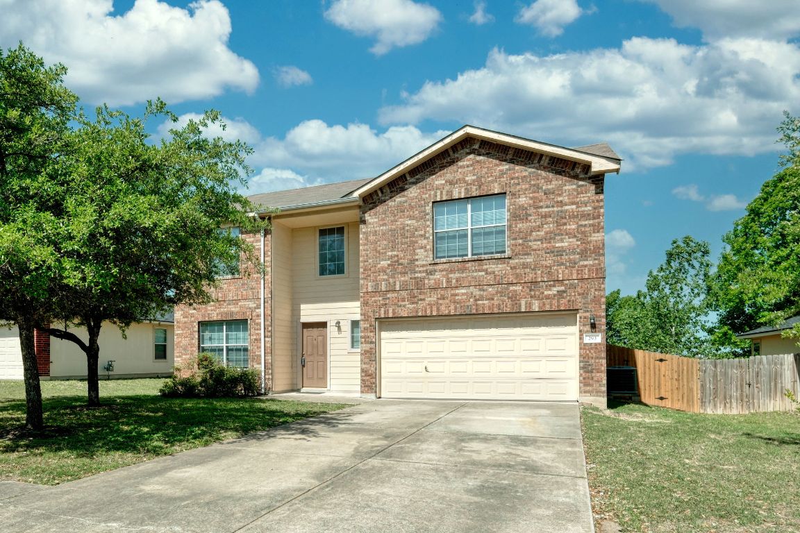 a front view of a house with a yard and garage