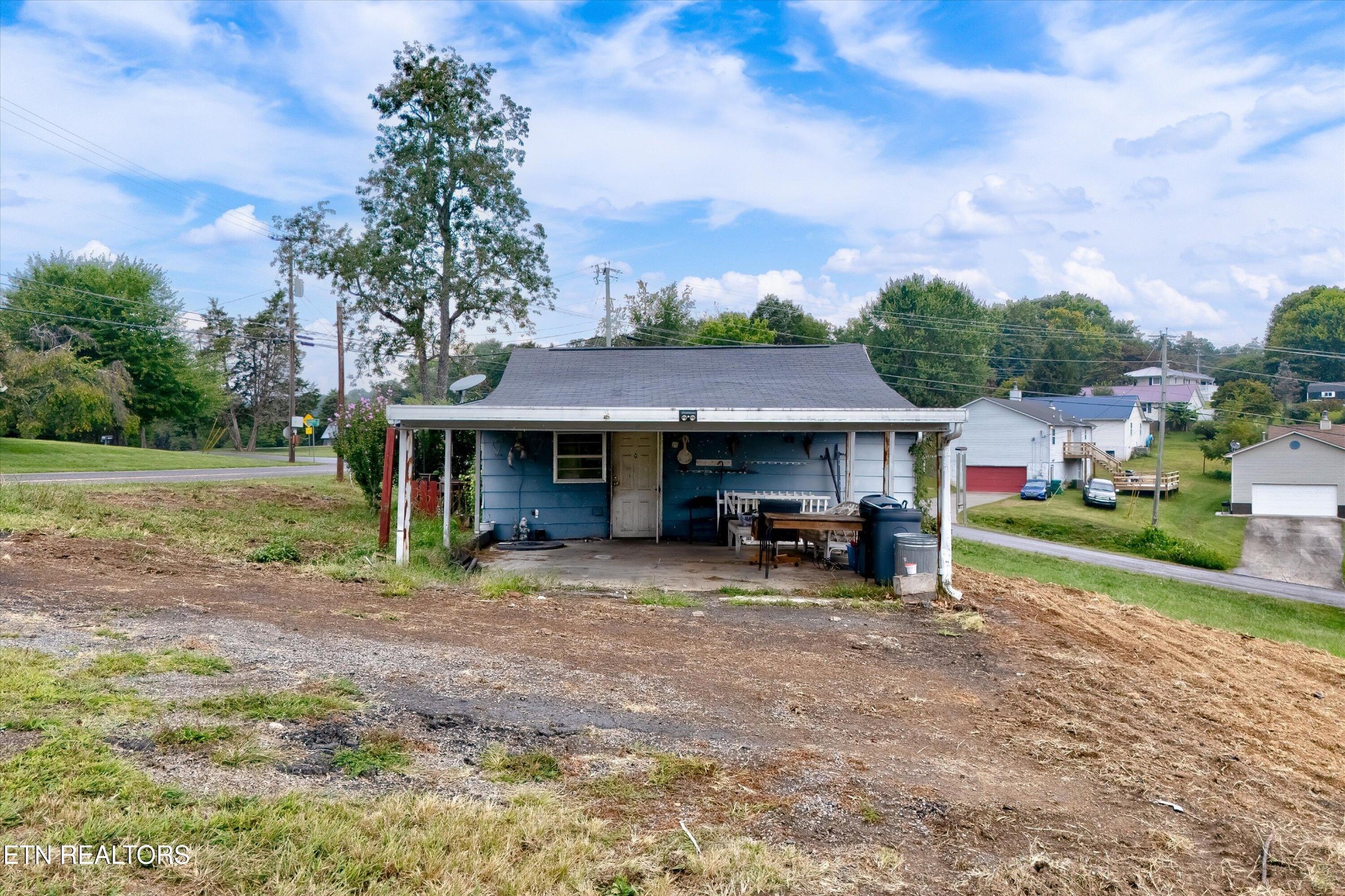 a view of a house with a yard and sitting area