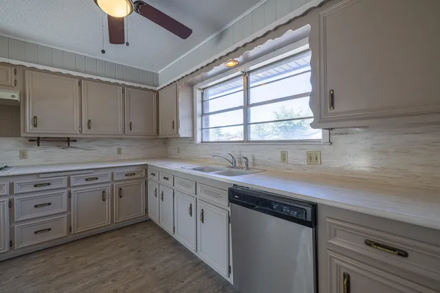 a kitchen with a sink cabinets and window