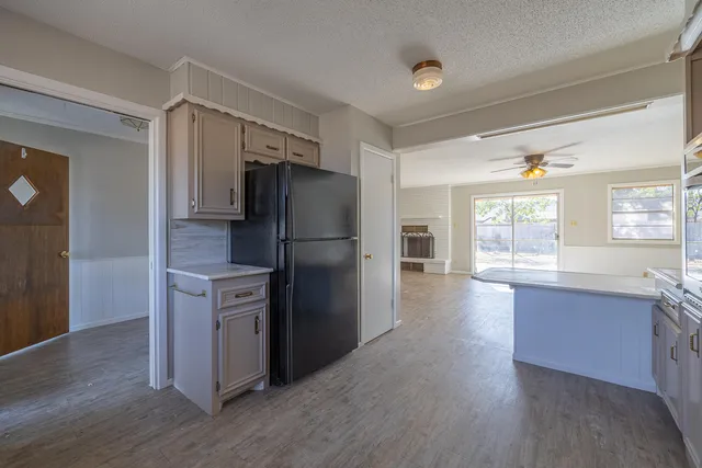 a kitchen with a refrigerator and a sink