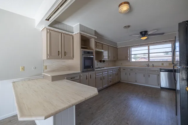 a kitchen with stainless steel appliances a sink and a microwave