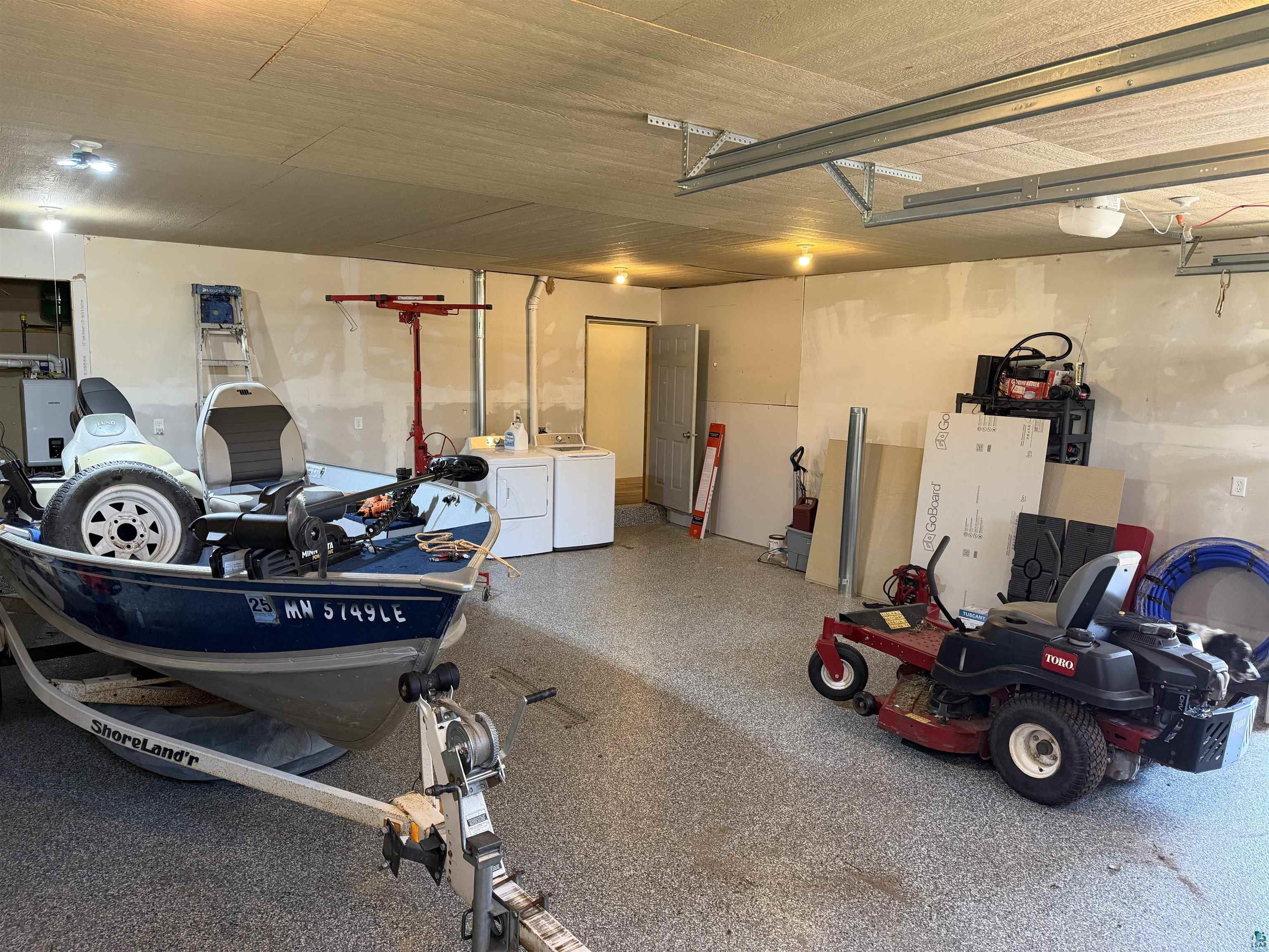 5274 Marble Lake Road Two Harbors, MN 55616 - Photo 52 of 79 Spacious garage featuring a durable speckled epoxy floor, overhead lighting, and ample wall space