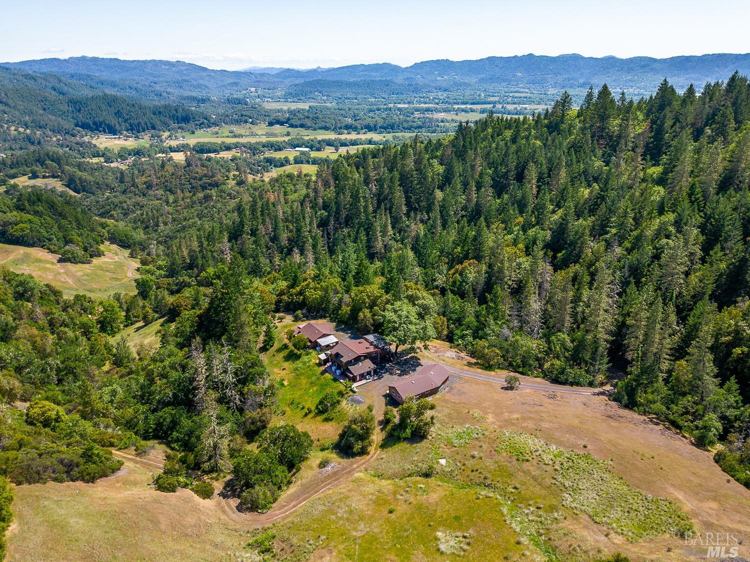 4242 Canyon Road Willits, CA 95490 - Photo 1 of 1 a view of a lush green hillside and a houses