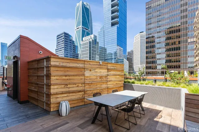 a backyard of a house with barbeque oven table and chairs