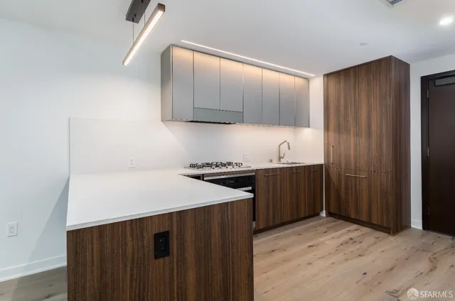 a kitchen with a sink a stove and cabinets
