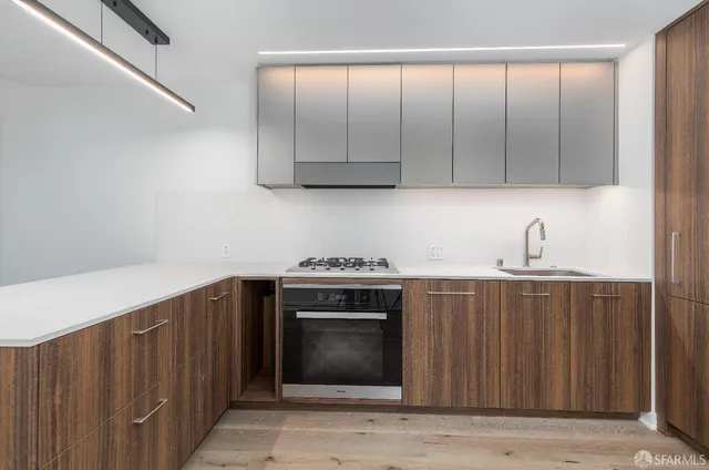 a kitchen with granite countertop a stove and a sink