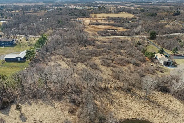 a view of a dry yard with wooden fence