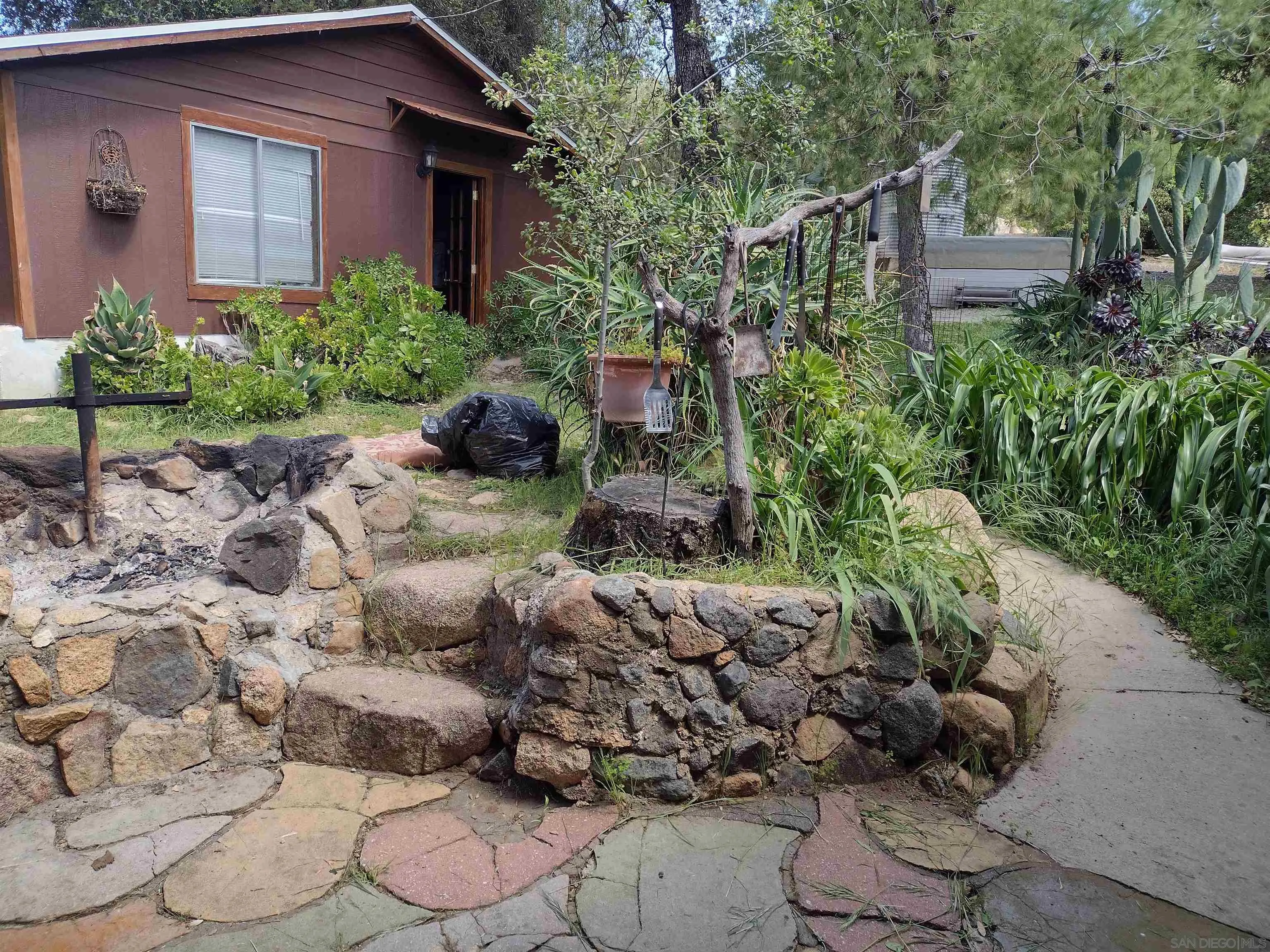17661 Lyons Valley Road Jamul, CA 91935 - Photo 13 of 50 a front view of a house with a yard and fountain