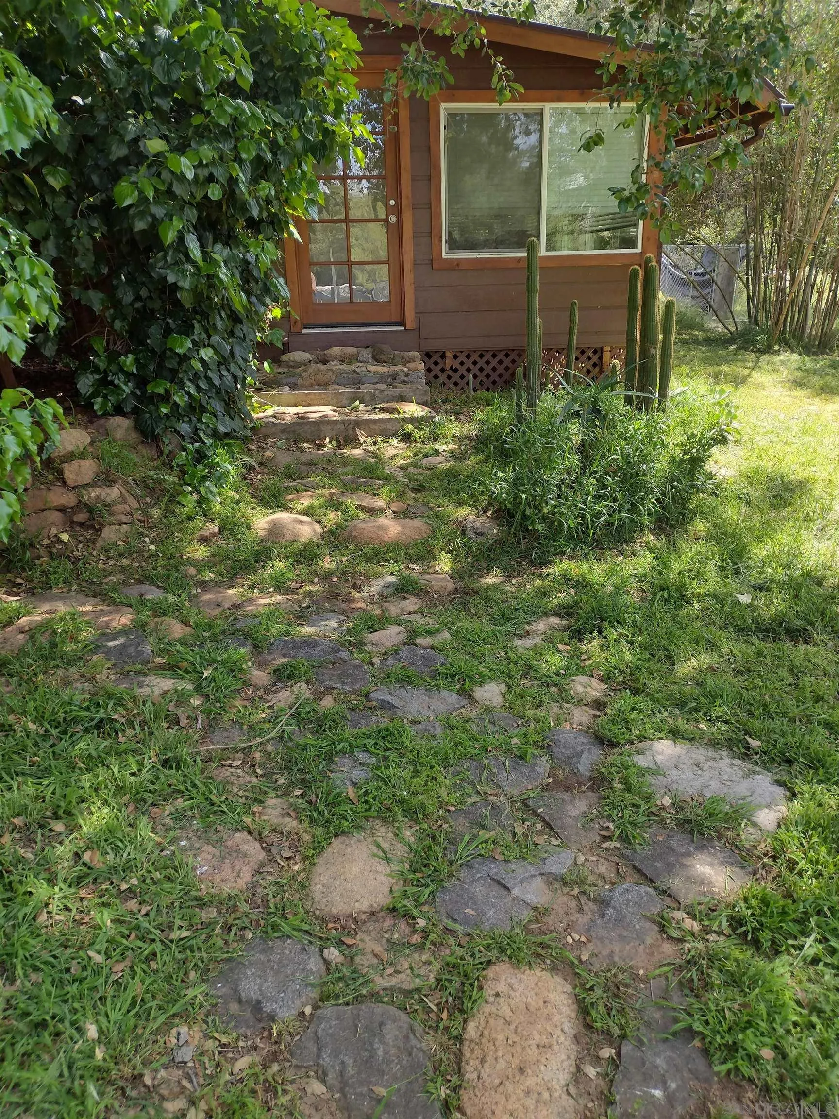 17661 Lyons Valley Road Jamul, CA 91935 - Photo 7 of 50 a view of a backyard with table and chairs and large tree