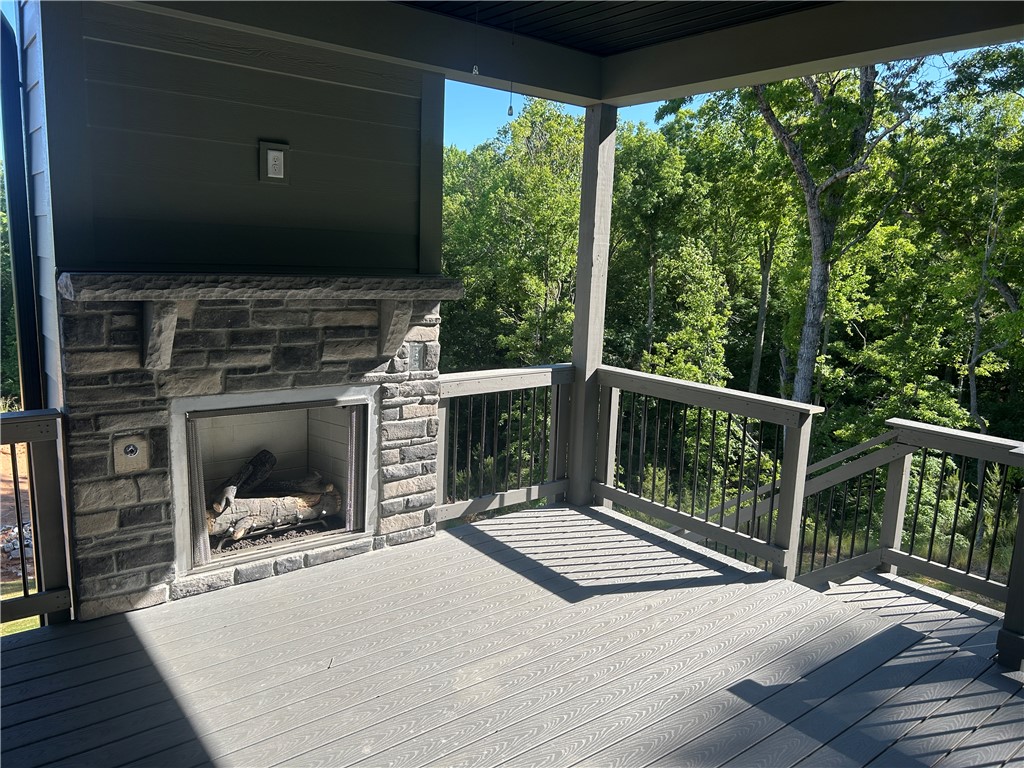 131 Shale Drive Central, SC 29630 - Photo 7 of 11 Enjoy outdoor living with a cozy fireplace on this expansive covered deck.