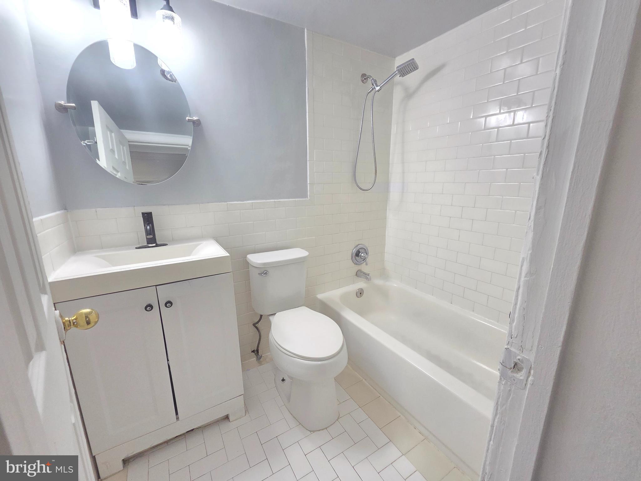 12658 Dara Drive, Unit 102 Woodbridge, VA 22192 - Photo 14 of 19 a bathroom with a sink toilet and shower