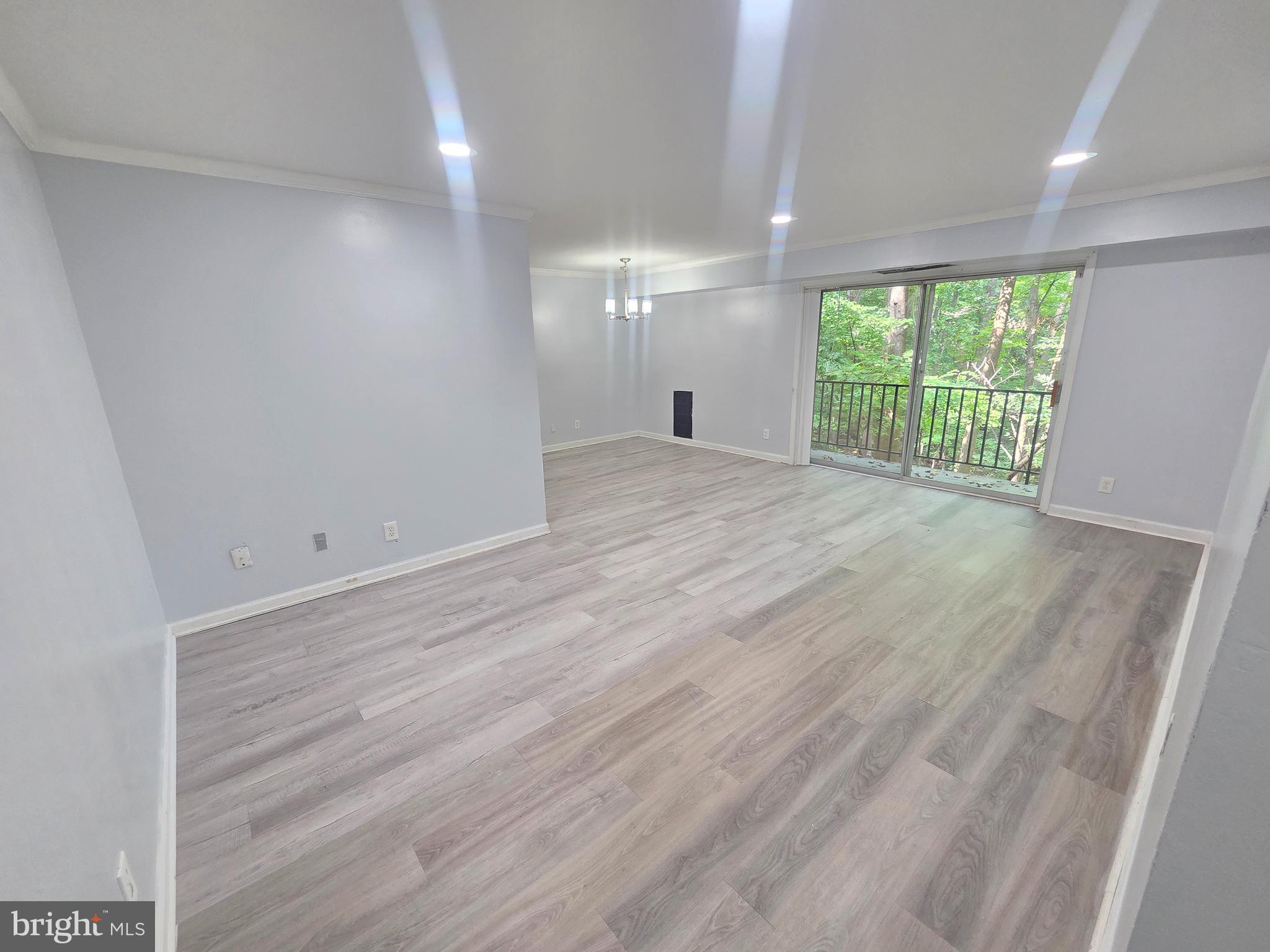 12658 Dara Drive, Unit 102 Woodbridge, VA 22192 - Photo 2 of 19 an empty room with wooden floor and windows