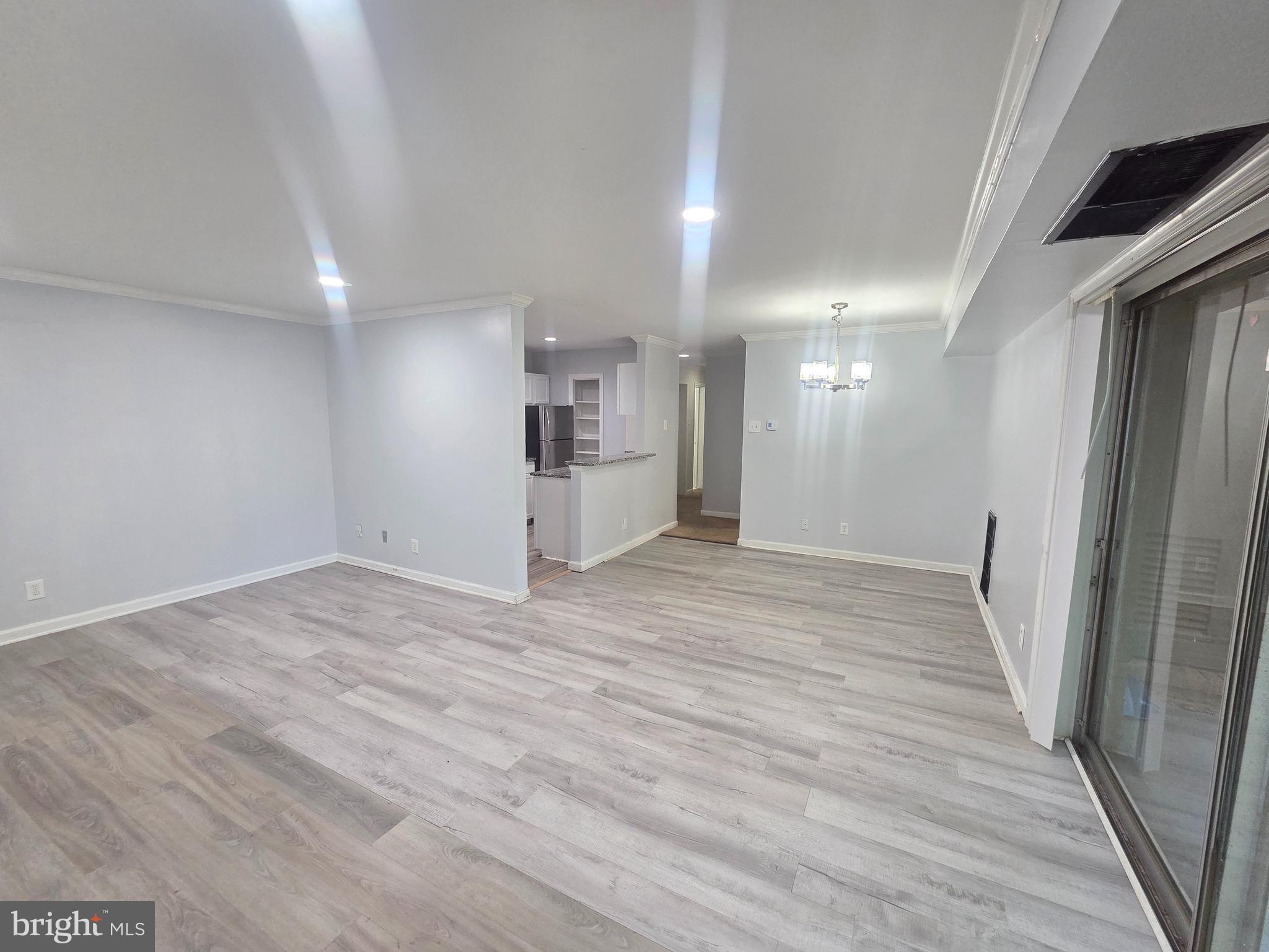 12658 Dara Drive, Unit 102 Woodbridge, VA 22192 - Photo 4 of 19 a view of a big room with wooden floor and a window