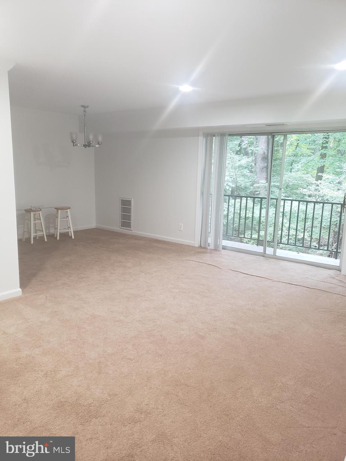 12658 Dara Drive, Unit 102 Woodbridge, VA 22192 - Photo 7 of 19 wooden floor in an empty room with a window