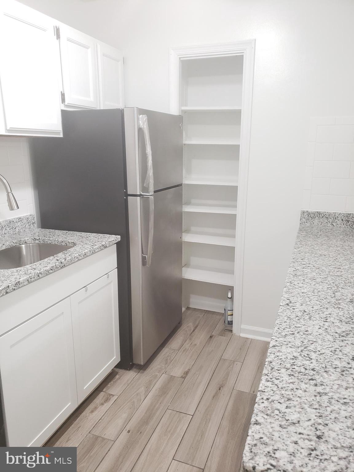 12658 Dara Drive, Unit 102 Woodbridge, VA 22192 - Photo 10 of 19 a storage room with wooden floor washer and dryer