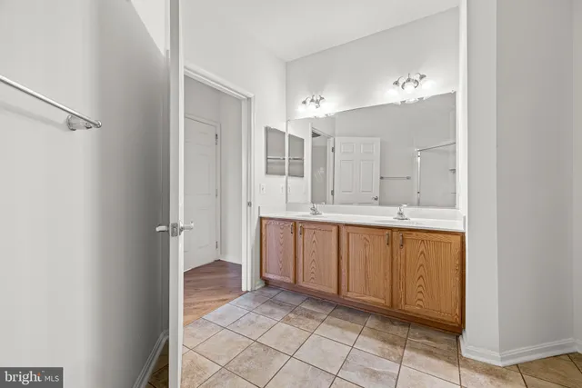 a bathroom with a double vanity sink mirror and