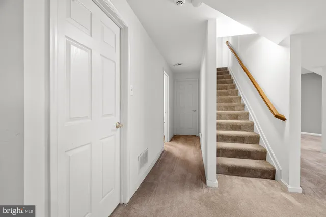 a view of an empty room with stairs