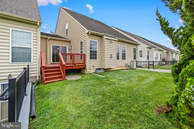 a view of a house with wooden deck