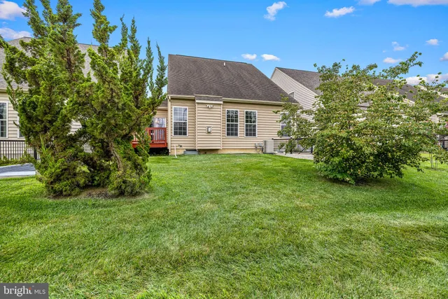 a view of a house with a yard and sitting area