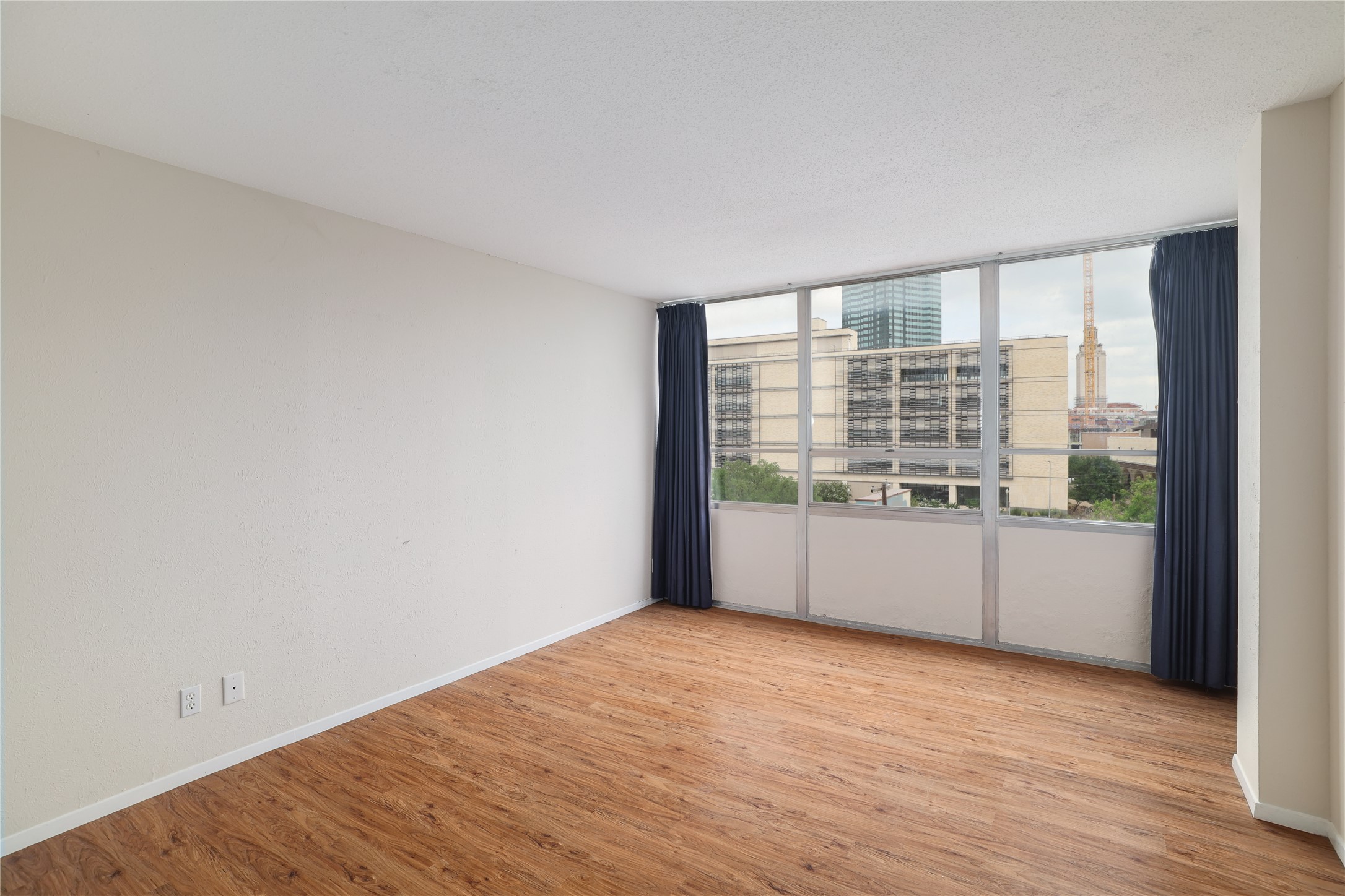 1800 Lavaca Street, Unit A508 Austin, TX 78701 - Photo 18 of 25 First bedroom offers natural light, laminate flooring, closet and views of UT Campus.