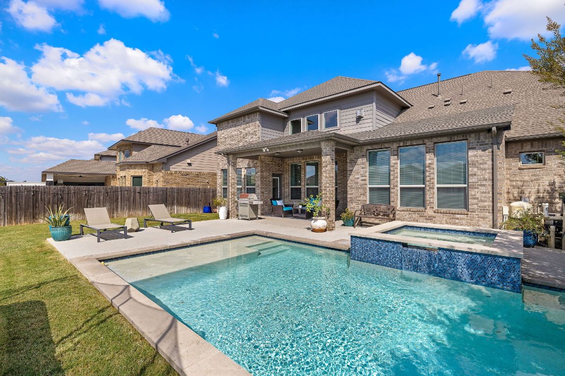 504 Leon Loop Liberty Hill, TX 78642 - Photo 1 of 40 a view of a house with swimming pool and sitting area