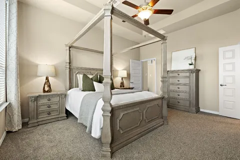 a bedroom with a bed and a chandelier