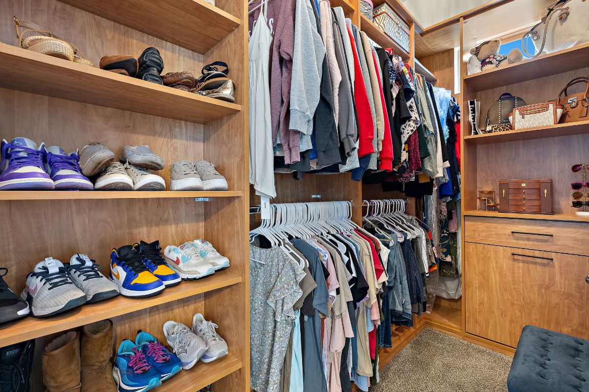 504 Leon Loop Liberty Hill, TX 78642 - Photo 21 of 40 a view of walk in closet with clothes and shoes