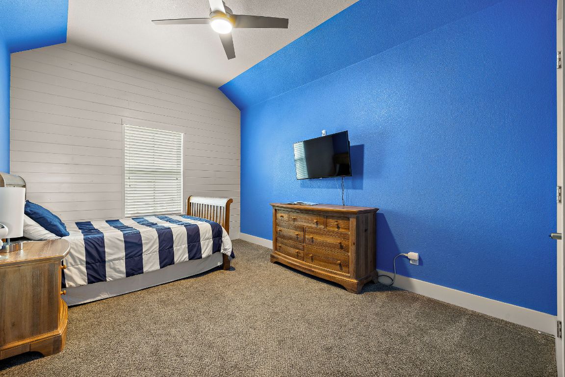 504 Leon Loop Liberty Hill, TX 78642 - Photo 25 of 40 a spacious bedroom with a bed and a flat screen tv