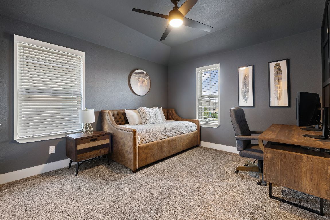 504 Leon Loop Liberty Hill, TX 78642 - Photo 26 of 40 a bedroom with a bed and a window