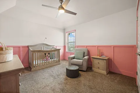 a bedroom with furniture and a baby crib