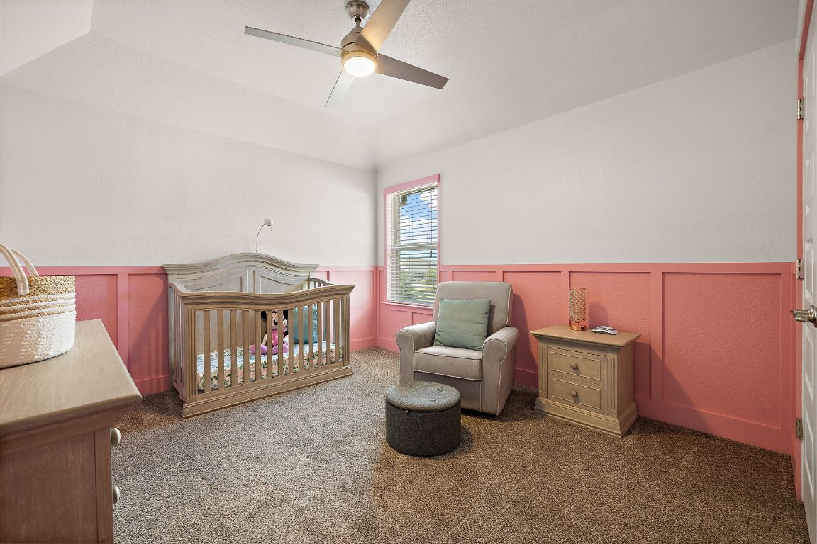 504 Leon Loop Liberty Hill, TX 78642 - Photo 27 of 40 a bedroom with furniture and a baby crib