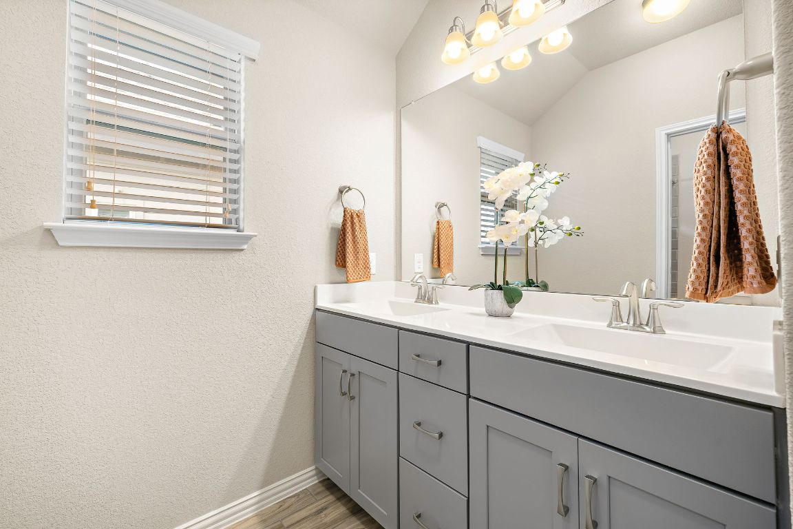 504 Leon Loop Liberty Hill, TX 78642 - Photo 28 of 40 a bathroom with a sink a vanity and a mirror