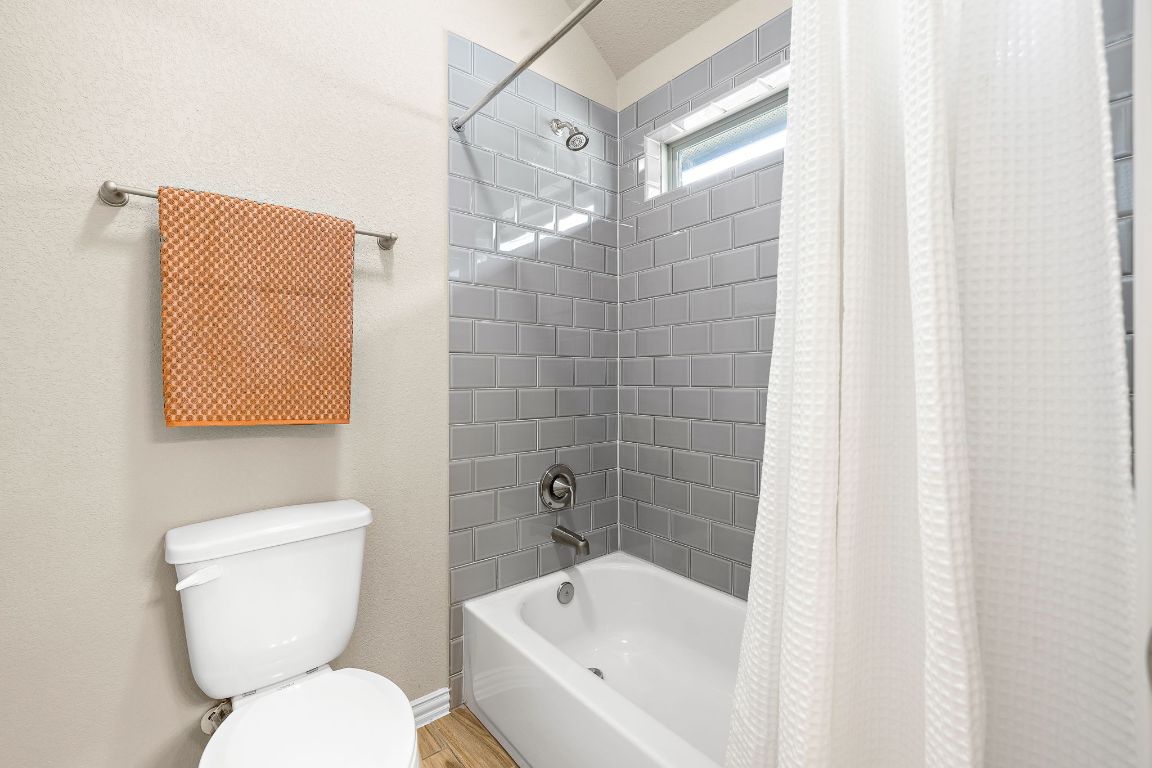 504 Leon Loop Liberty Hill, TX 78642 - Photo 29 of 40 a bathroom with a toilet and a bathtub