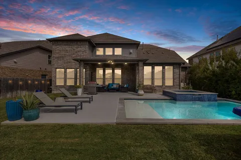 a view of a patio with couches table and chairs and potted plants