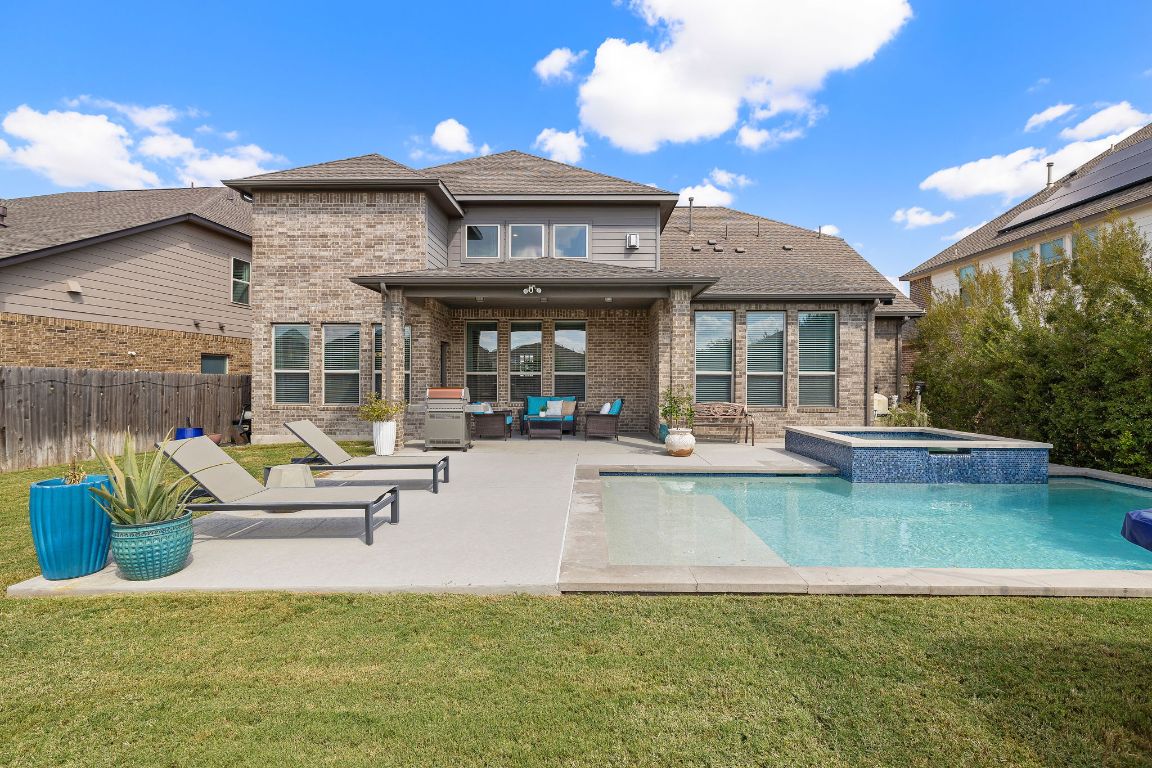 504 Leon Loop Liberty Hill, TX 78642 - Photo 36 of 40 a view of a house with pool and chairs