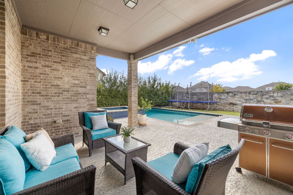 504 Leon Loop Liberty Hill, TX 78642 - Photo 37 of 40 a outdoor living space with furniture and a floor to ceiling window