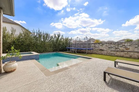 a view of swimming pool with a yard and sitting area