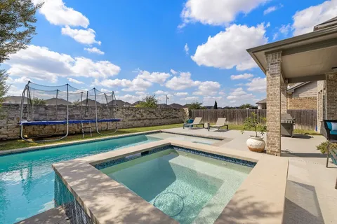 a view of swimming pool with outdoor seating and city view