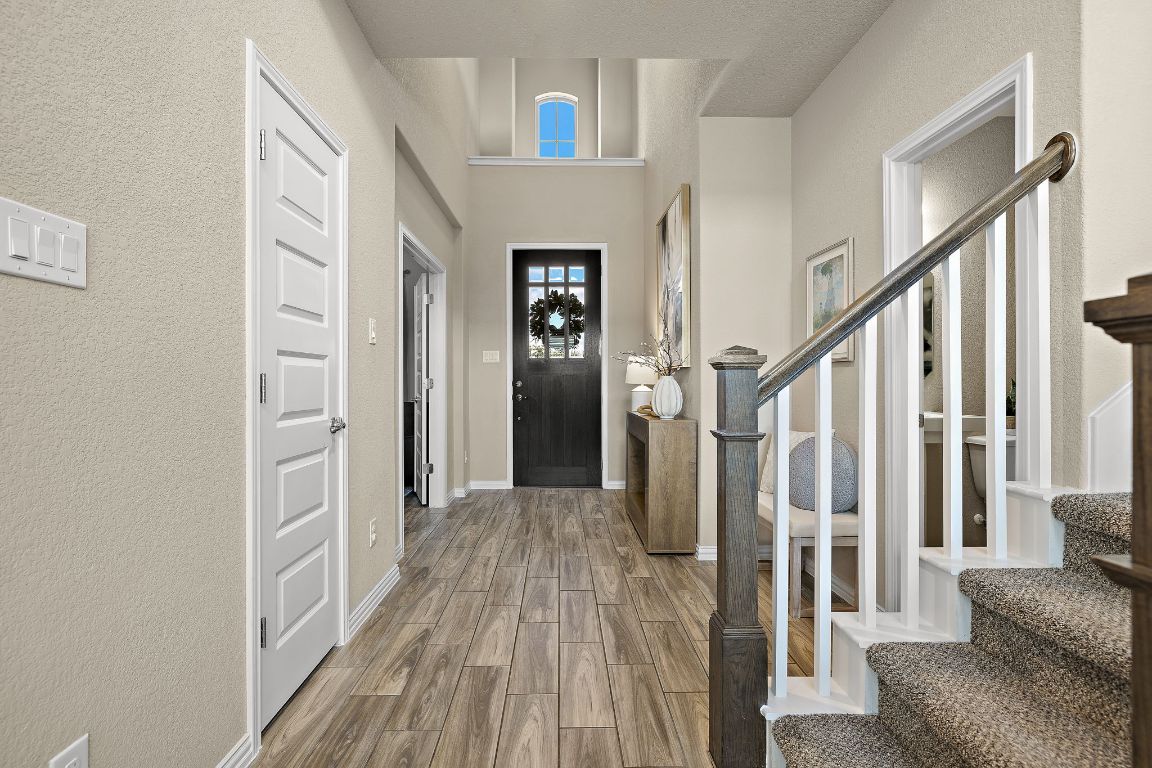 504 Leon Loop Liberty Hill, TX 78642 - Photo 4 of 40 a view of a livingroom with wooden floor and stairs