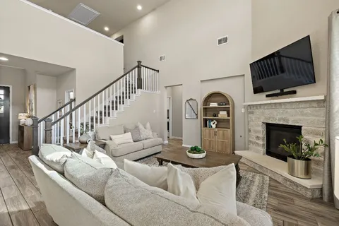 a living room with furniture fireplace and flat screen tv