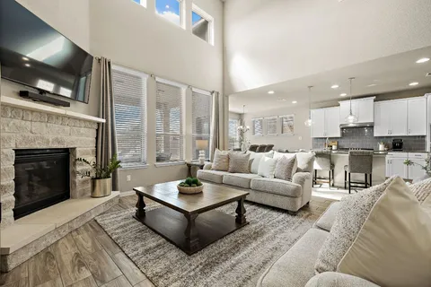 a living room with furniture wooden floor and a fireplace
